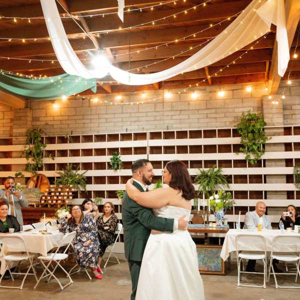 Bride and groom dancing at a decorated wedding reception