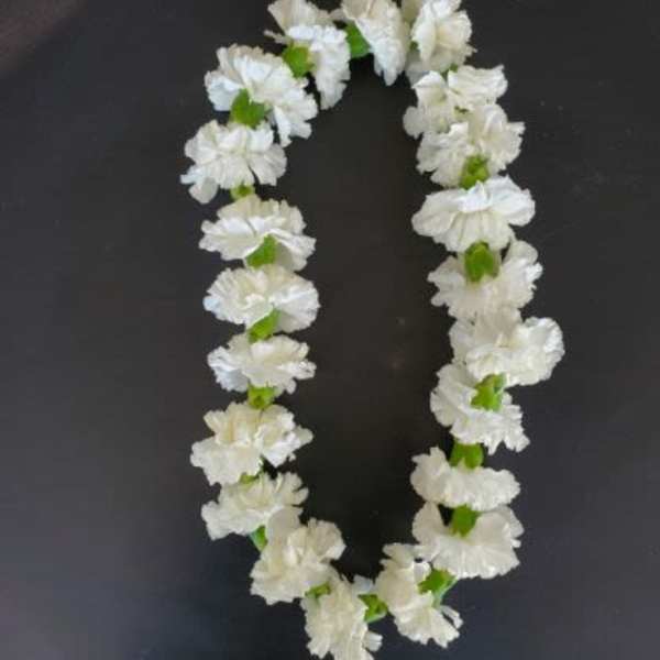 White flower lei on a dark background