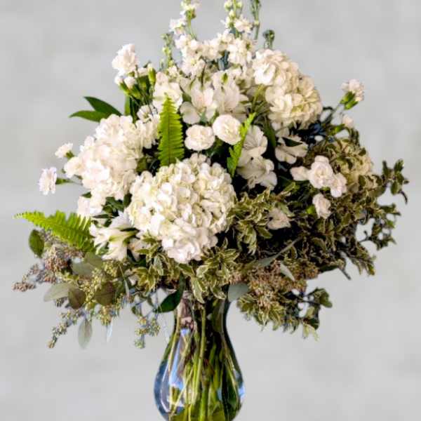 White floral arrangement in a clear glass vase