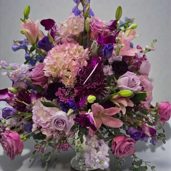 Lavender and pink floral arrangement in a clear glass vase