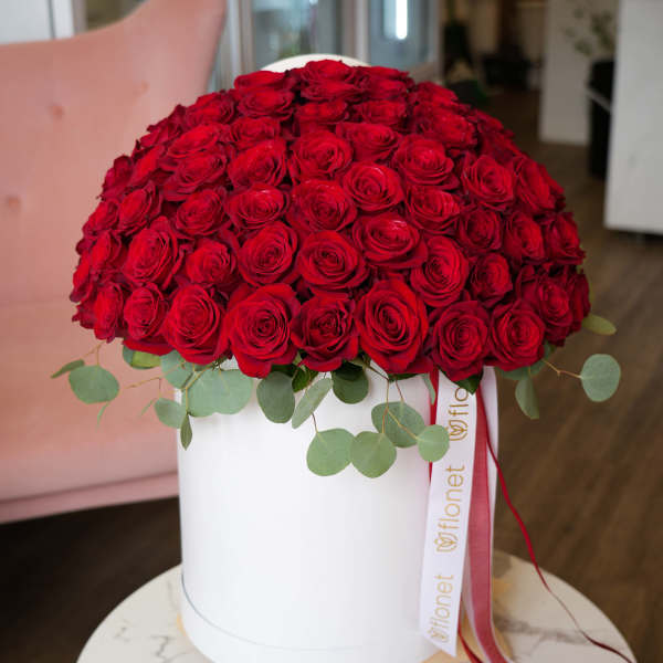 Large dome of red roses in a white hat box with ribbon