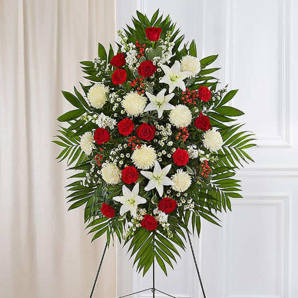Standing funeral spray with red roses, white lilies, and white pompons