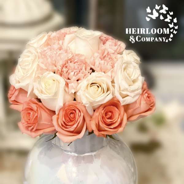 Pink and white rose bouquet in a clear round vase