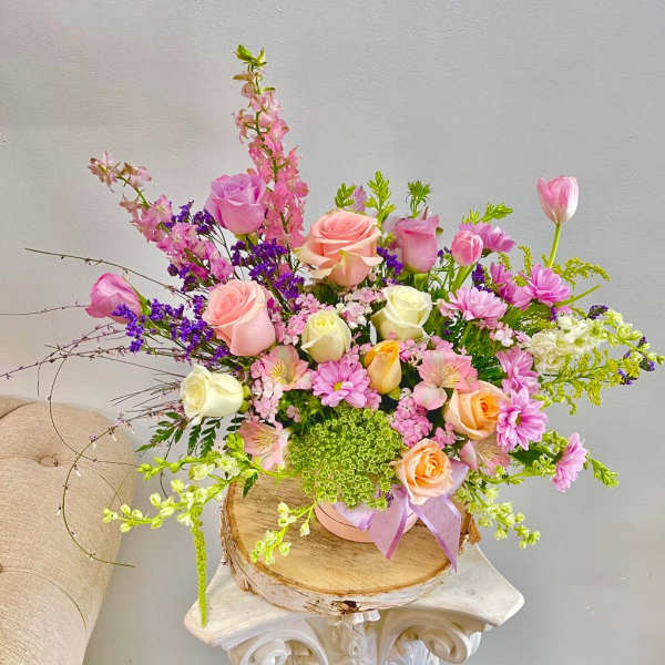 Mixed bouquet of pink and peach roses with purple and white flowers