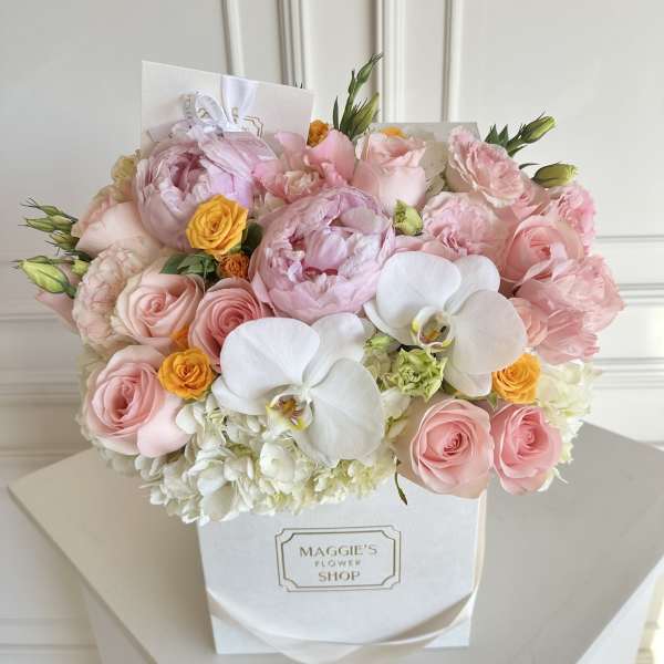 Pink and white flower bouquet in a white gift box