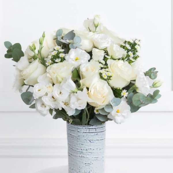 White rose bouquet in a textured silver vase