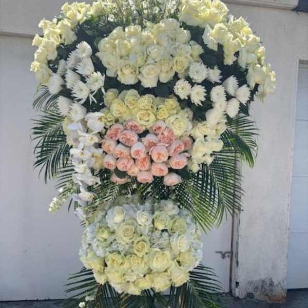 Large standing floral spray with white and blush roses and orchids