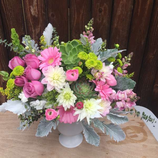 Pink and white mixed flower arrangement in a white vase