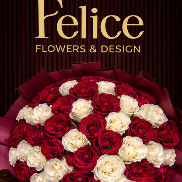 Bouquet of red and white roses wrapped in burgundy paper