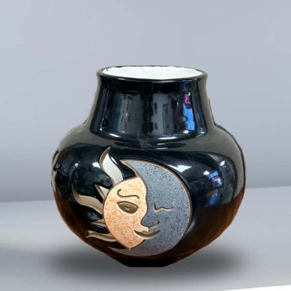Black ceramic vase with a sun and moon face design