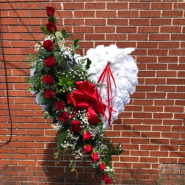 Standing heart-shaped floral tribute with red roses and white flowers