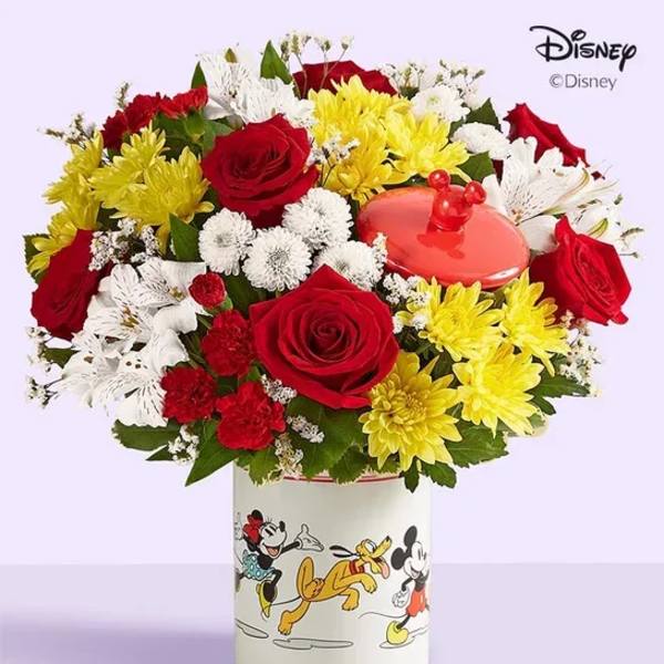 Bouquet of red, yellow, and white flowers in a Mickey Mouse vase