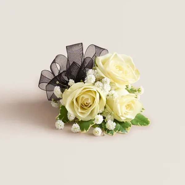Cream rose boutonniere with black ribbon and baby's breath