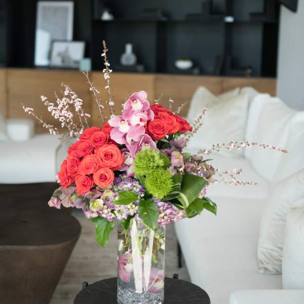 Pink and red floral arrangement in a clear glass vase