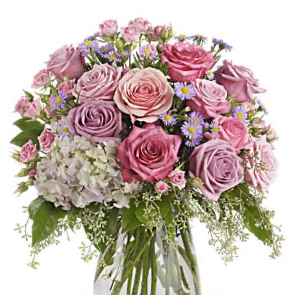 Pink and lavender rose bouquet in a clear glass vase