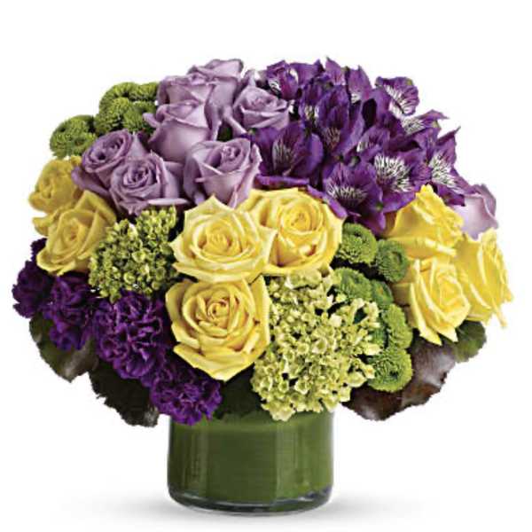 Bouquet of purple and yellow roses in a green glass vase