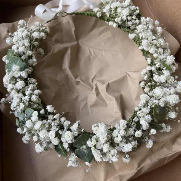 White baby's breath floral crown with ribbon ties in a box
