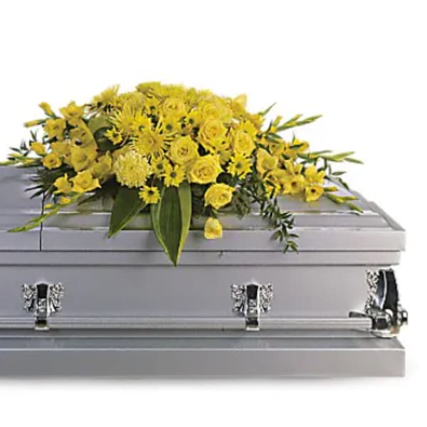 Yellow floral spray on a silver casket