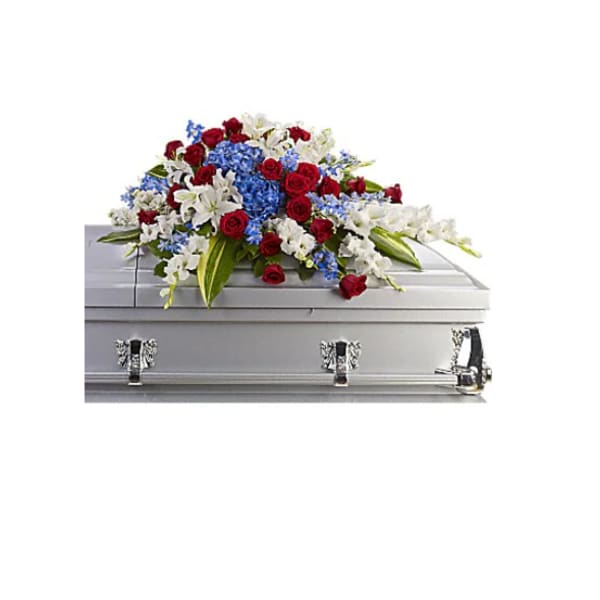 Red, white, and blue floral spray on a silver casket