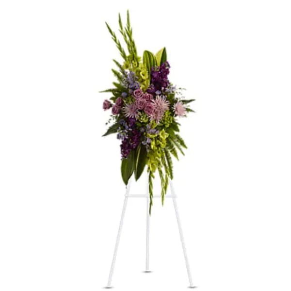 Tall purple and green floral standing spray on an easel