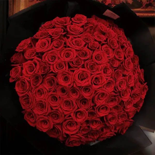 Large bouquet of red roses wrapped in black paper