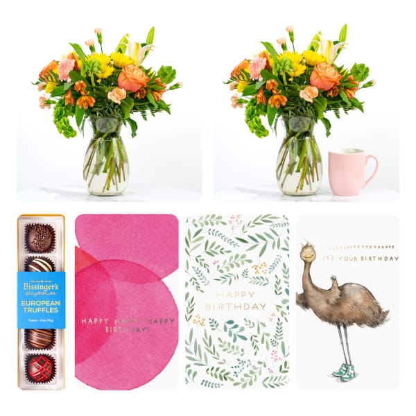 Mixed bouquet in a glass vase with a pink mug and gift items