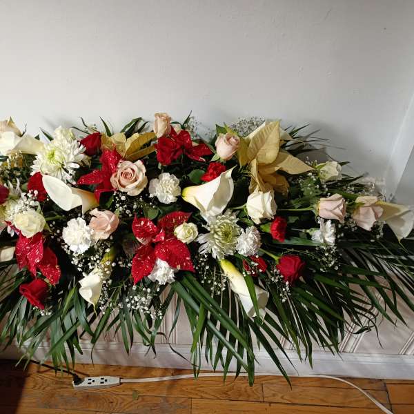 Large floral spray with red and white roses and calla lilies