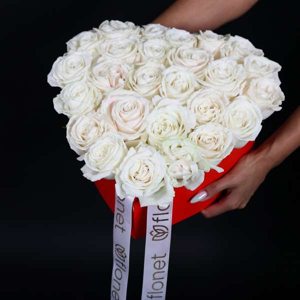 Bouquet of white roses in a red box with long ribbon tails