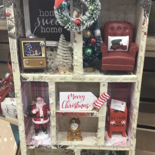 Miniature Christmas room display with Santa, a chair, and holiday decor