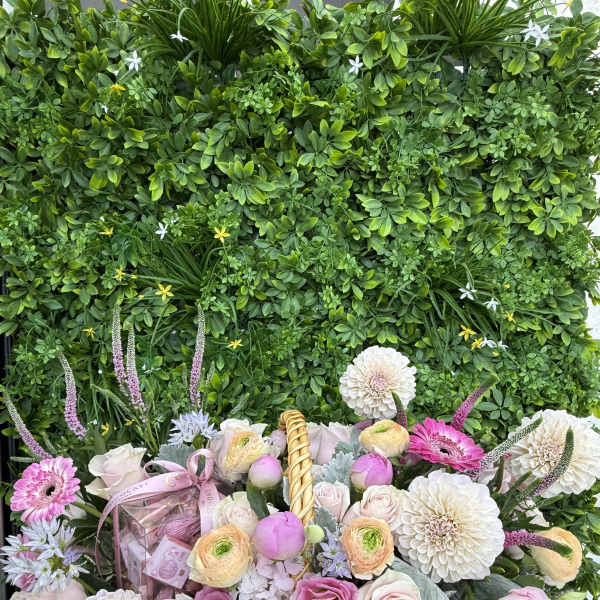 Basket arrangement of pink and white flowers with a gift box and ribbon