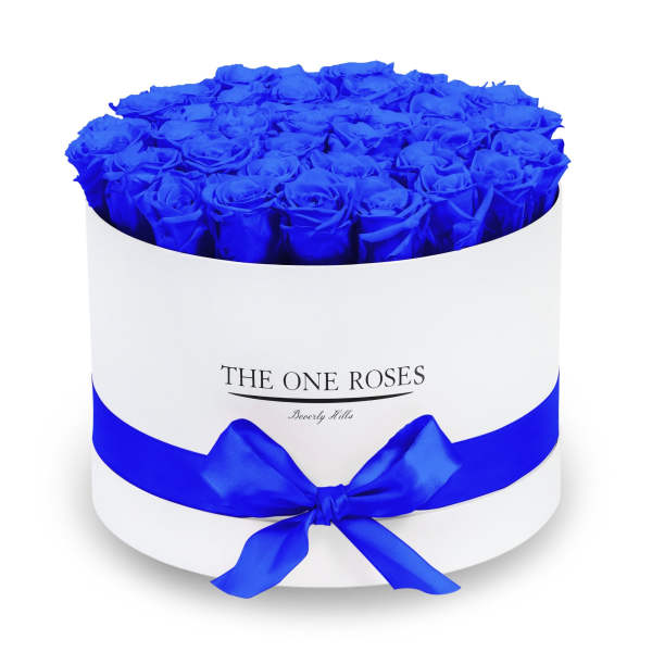 Round box filled with vivid blue roses and tied with a blue ribbon
