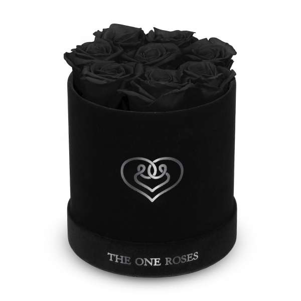 Black roses arranged in a round black box