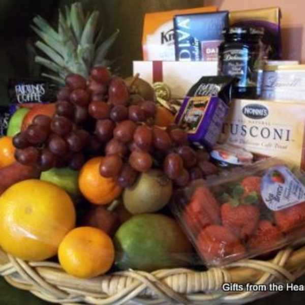 Fruit basket with grapes, strawberries, and assorted packaged snacks