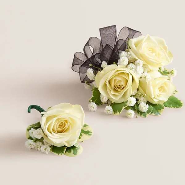 Cream rose boutonniere and matching floral cluster with black ribbon