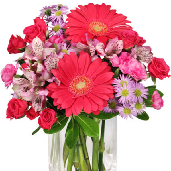 Pink and purple mixed bouquet in a clear glass vase