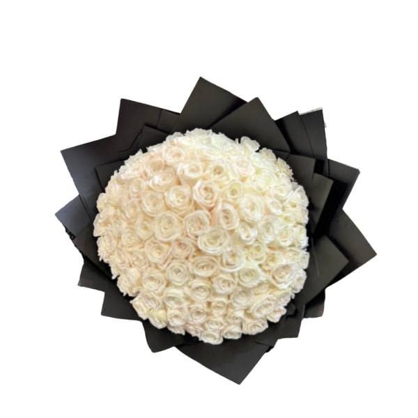 Round bouquet of white roses wrapped in black paper