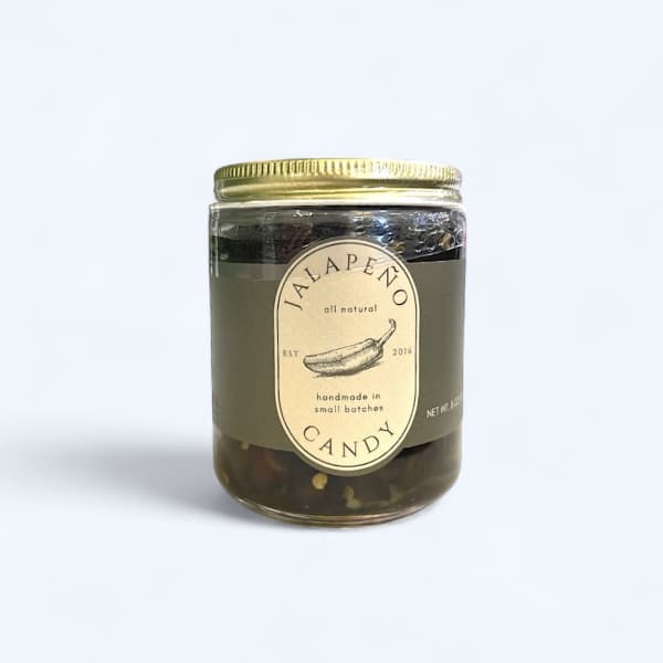 Jar candle with a gold lid and jalapeño label