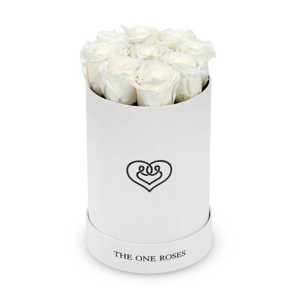 White roses arranged in a round white hat box with a heart logo