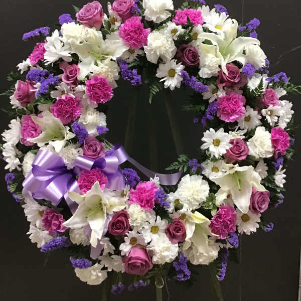 Heart-shaped floral wreath with pink, white, and purple flowers