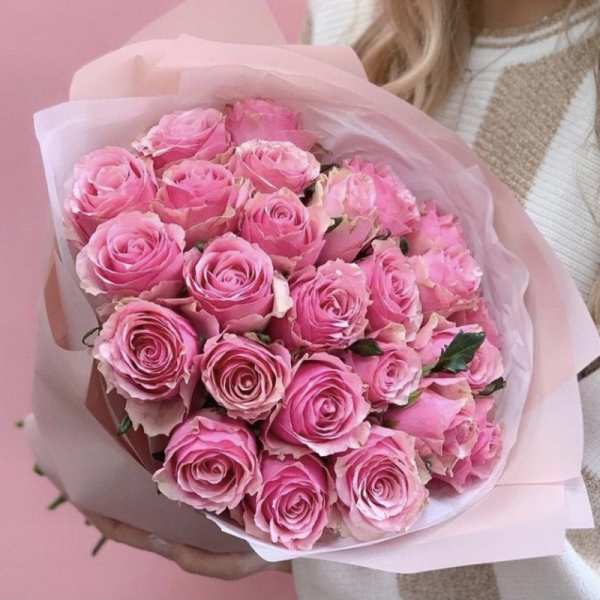 Bouquet of pink roses wrapped in pale pink paper