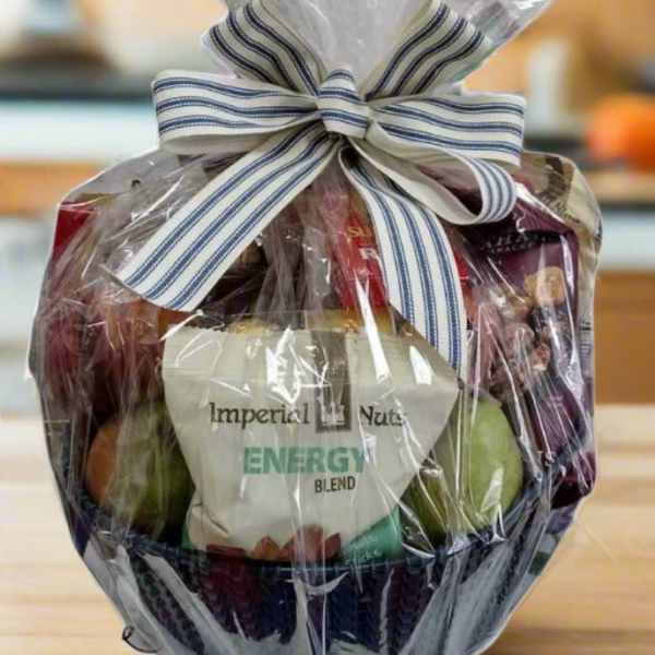 Gift basket wrapped in clear cellophane with a striped bow