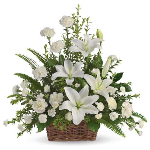 White lilies and carnations arranged in a wicker basket