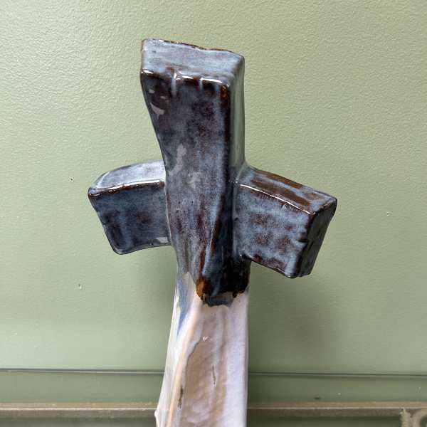 Ceramic cross wall hanging with blue, brown, and white glaze