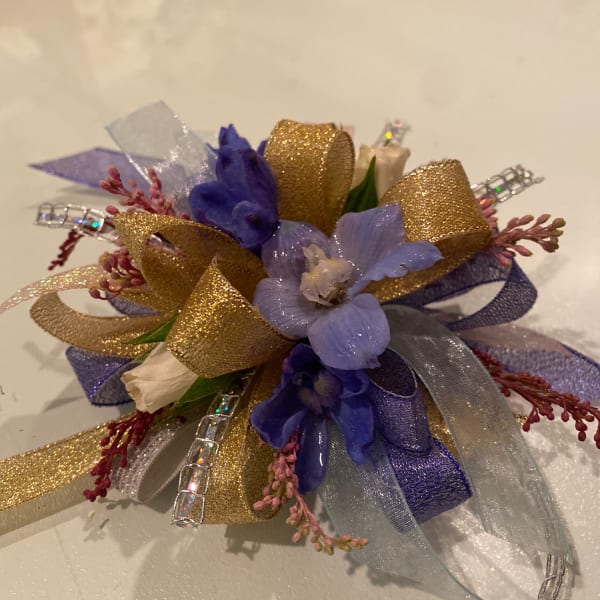 Small corsage with purple flowers and gold ribbon