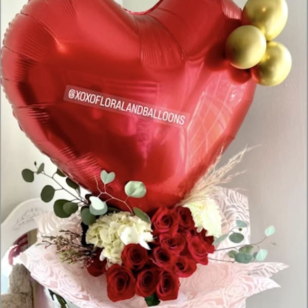 Red heart balloon with roses and a teddy bear gift arrangement