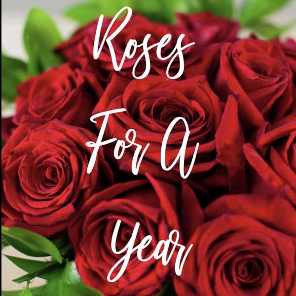 Close-up of a dense cluster of red roses with white script text overlaid