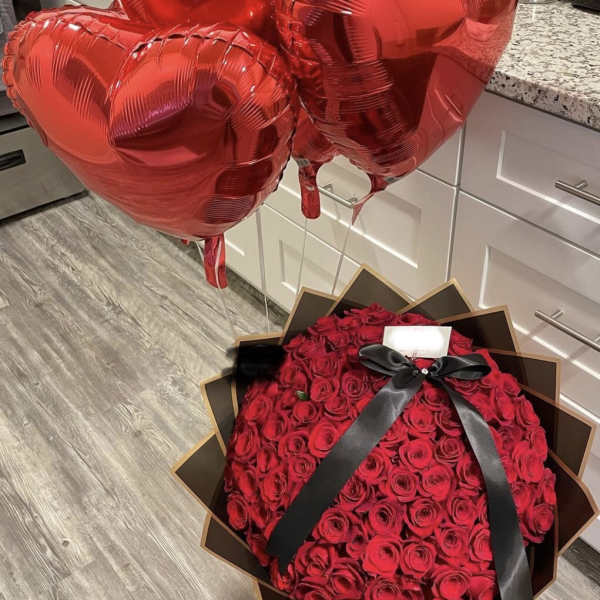 Bouquet of red roses with three red heart balloons