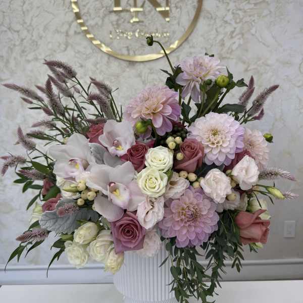 Pink and white floral arrangement in a white vase