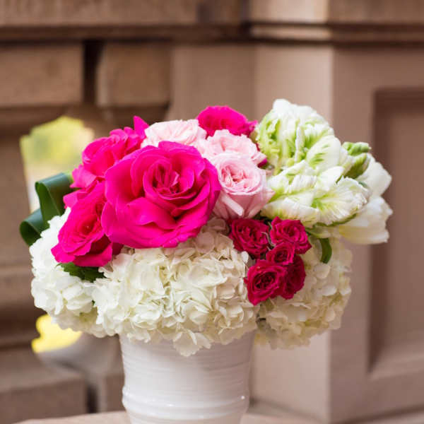 Pink and white rose bouquet in a white vase