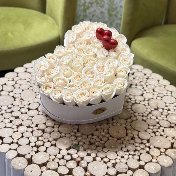 Heart-shaped box of white roses with red heart accents